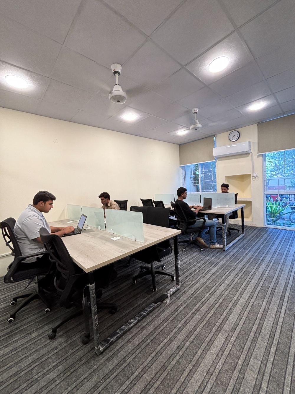 Open coworking hall with shared desks at WorkHive