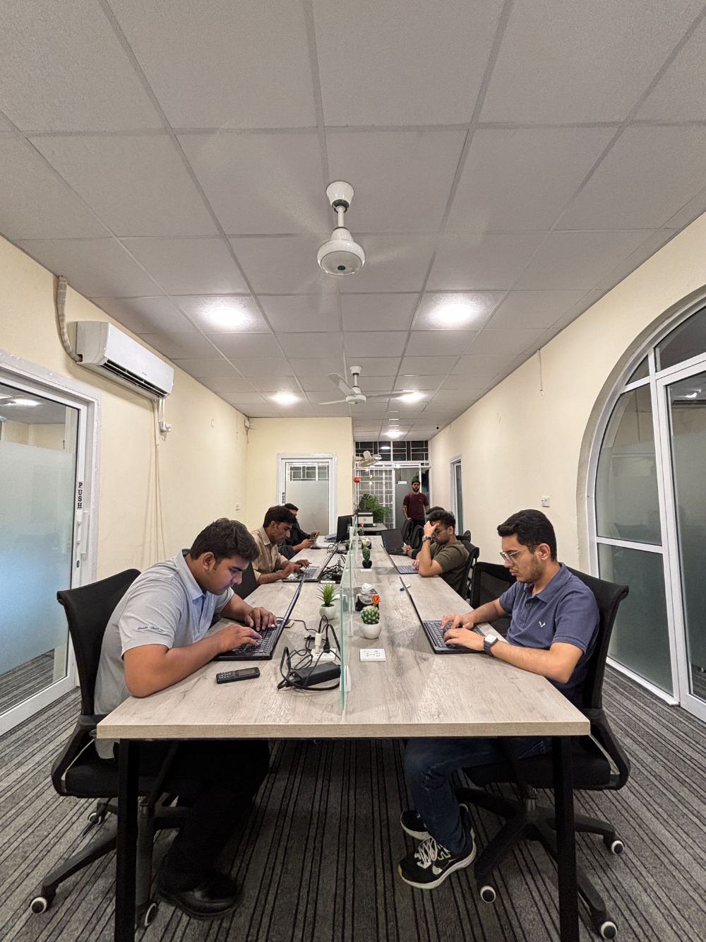 Long shared table with teams working at WorkHive
